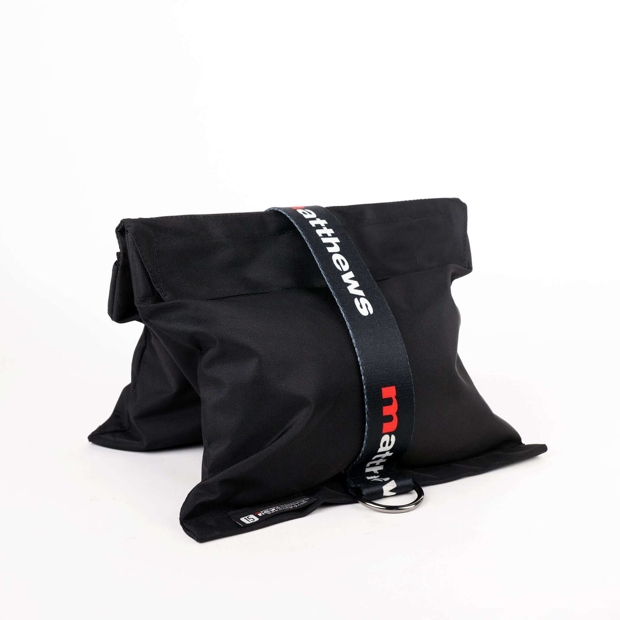 Black RoadBags sandbag with strap, designed for securing equipment and stabilizing stands on set.