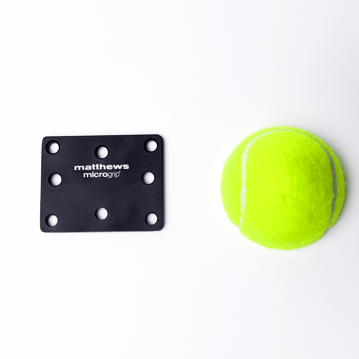 MICROGrip Master Rigging Kit components: black mounting plate with holes and bright green tennis ball.