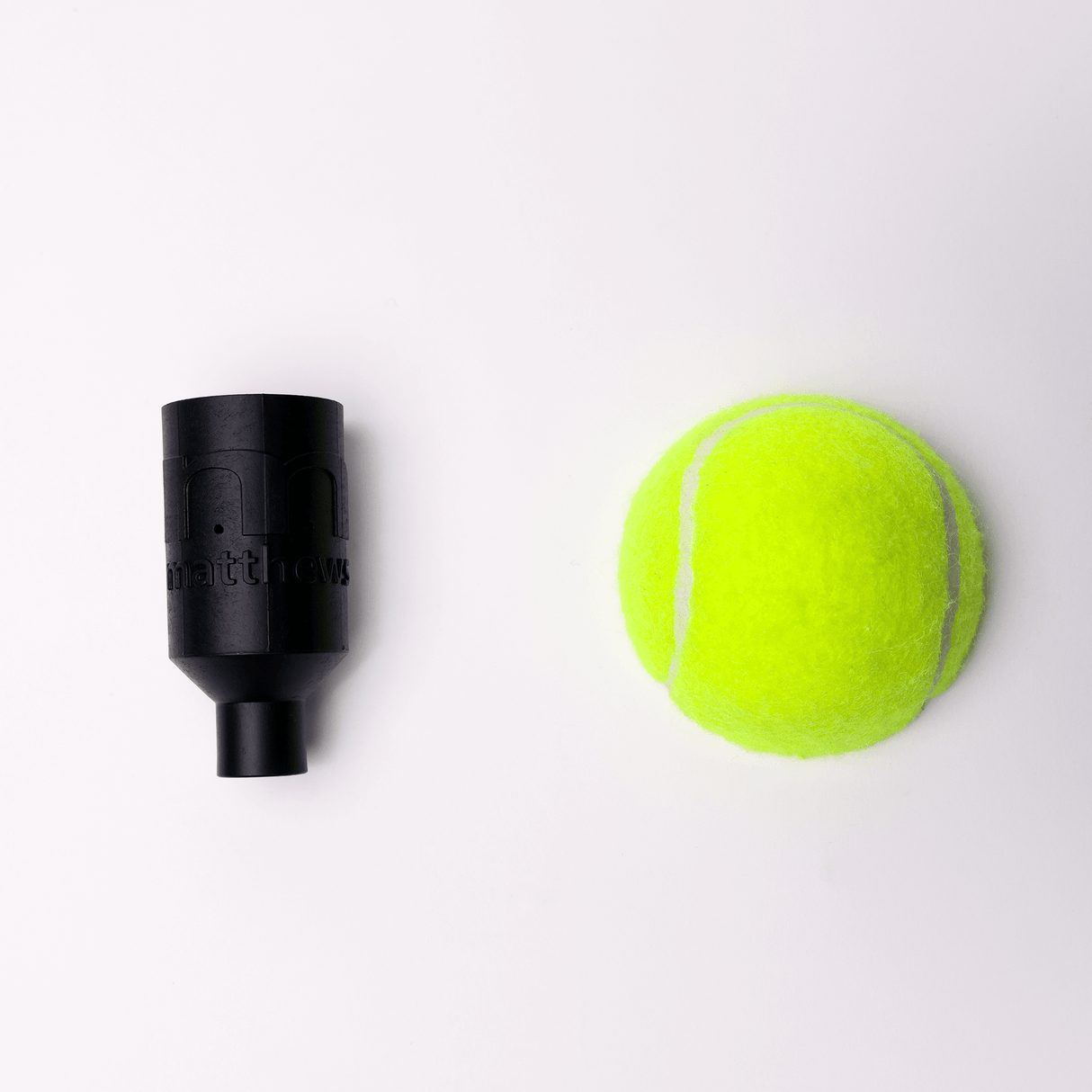 MICROGrip rigging accessory next to a bright yellow tennis ball on a white background.