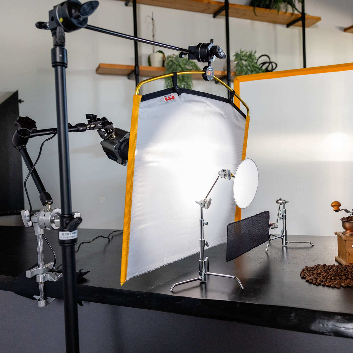 Professional photography setup with softbox, reflectors, and lighting for product shoots on a tabletop.