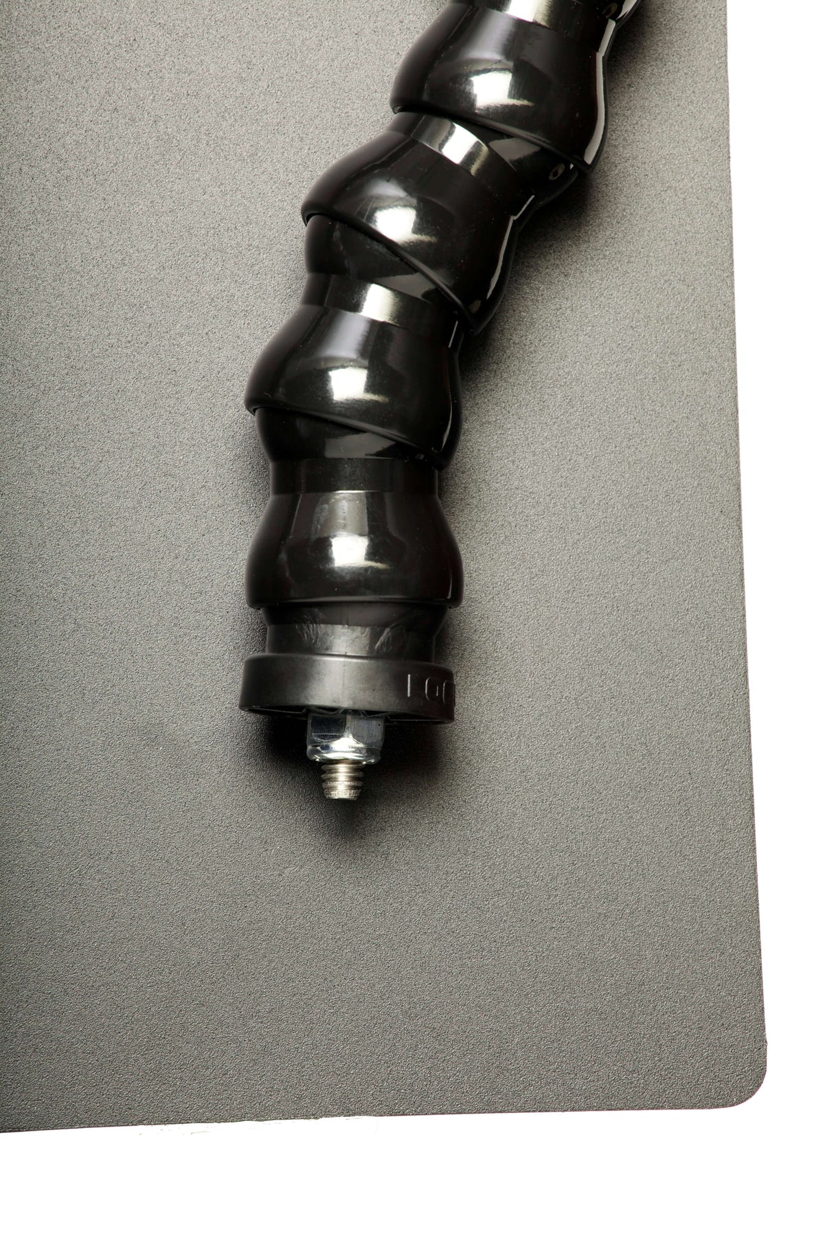 Close-up of the Dinkum Systems PRO™ Screw Mount lens shade, featuring a flexible black mount on a gray background.