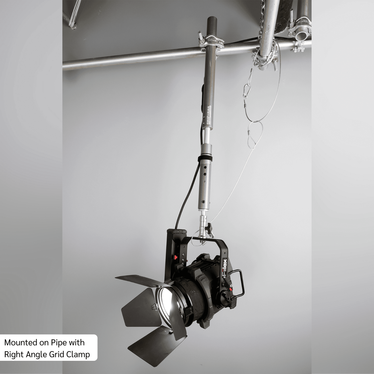 Grip Rail with Right Angle Grid Clamp holding a light fixture, showcasing versatility in lighting rigging.