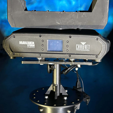 Chauvet Professional Maverick Storm moving light mounted on a sturdy stand in a production setting.