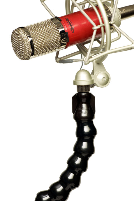 Close-up of a microphone with a flexible mount, showcasing professional audio equipment for recording.