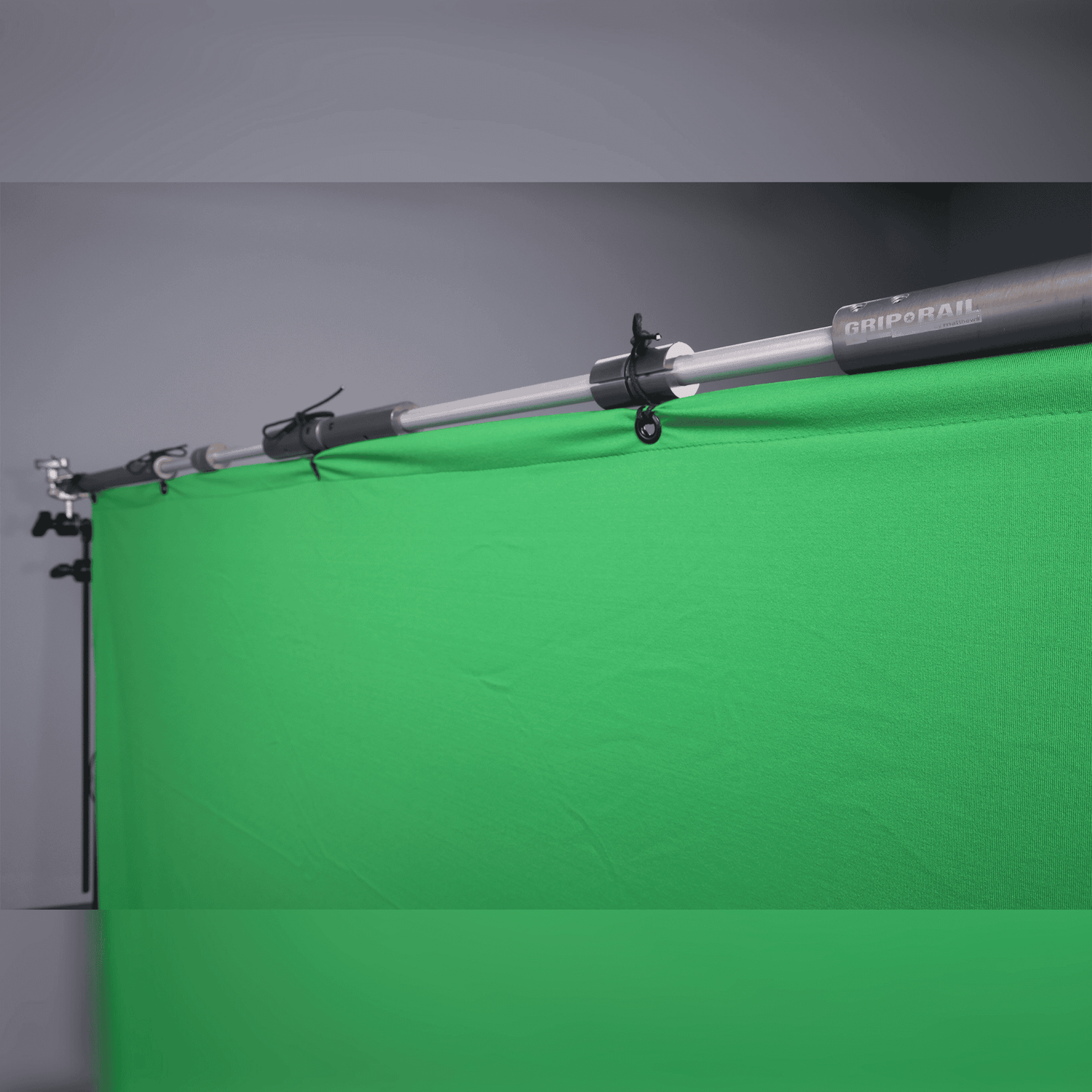 Grip Rail telescoping grid pipe system holding a green backdrop for versatile imaging applications.