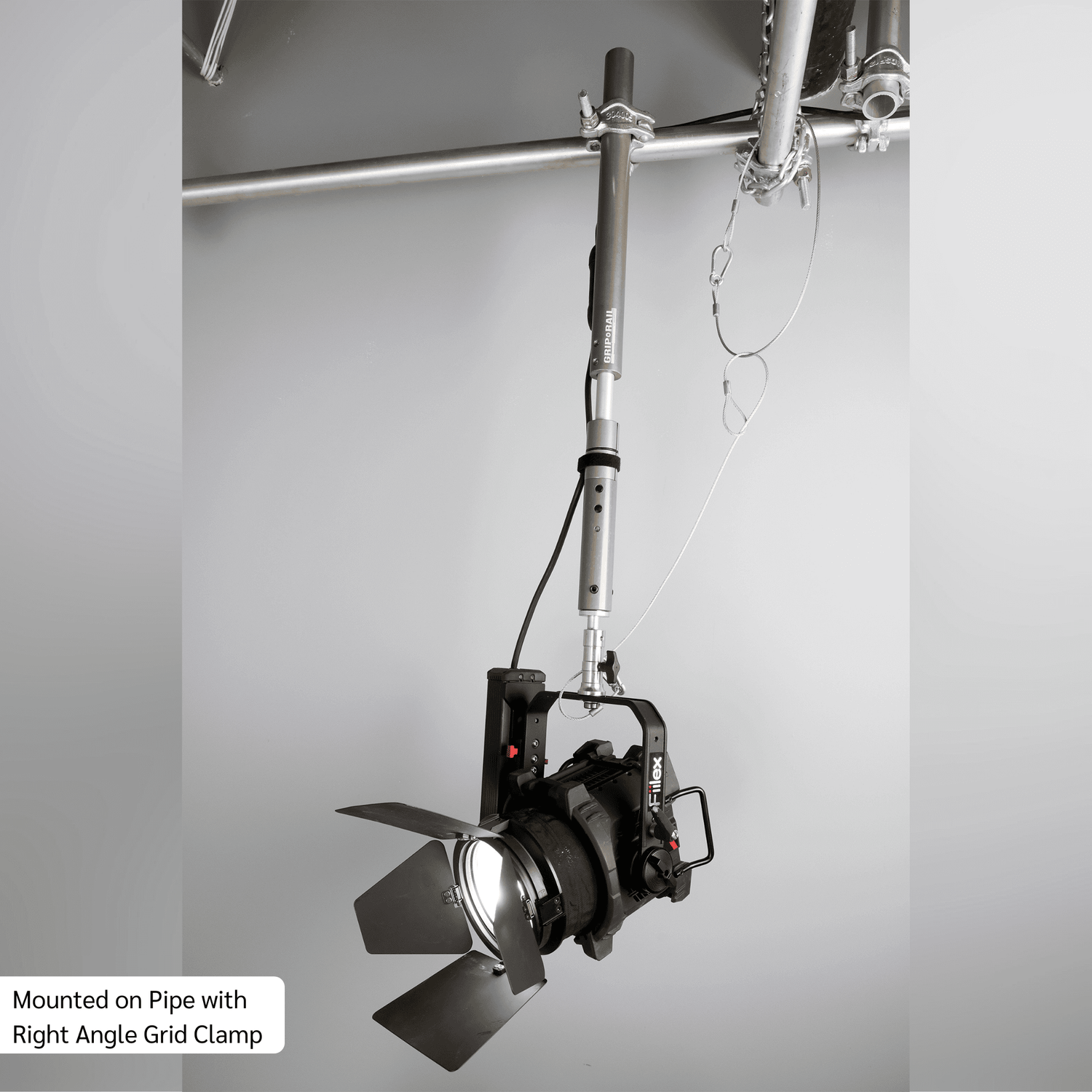 Grip Rail with Right Angle Grid Clamp holding a light fixture, showcasing versatility in lighting rigging.