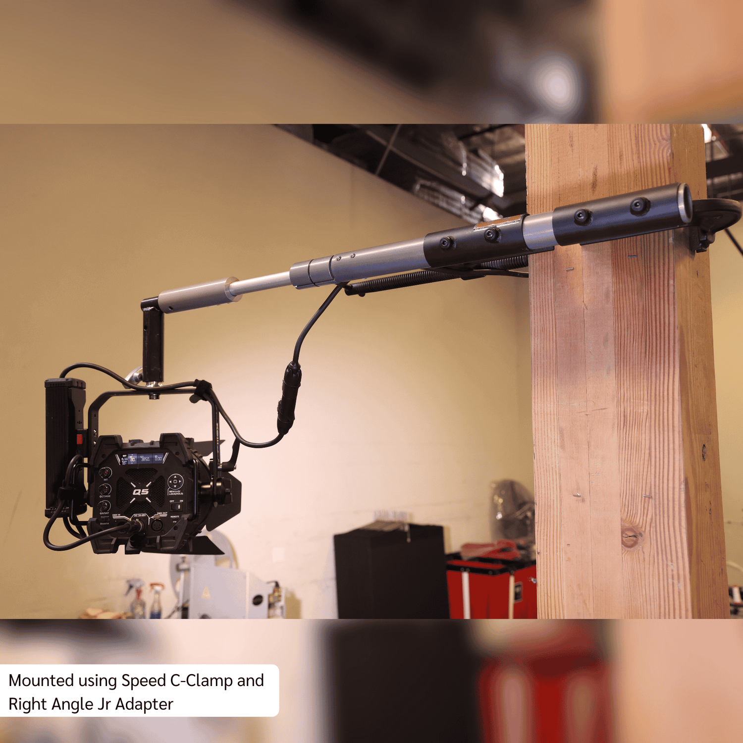 Grip Rail mounted with Speed C-Clamp and Right Angle Jr Adapter, supporting a professional camera setup in a studio.