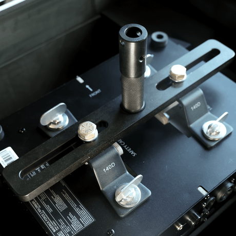 Moving Light Stand Adapter "Cotone Mount" showcasing dual-slotted plate and knurled jr pin for secure attachment.