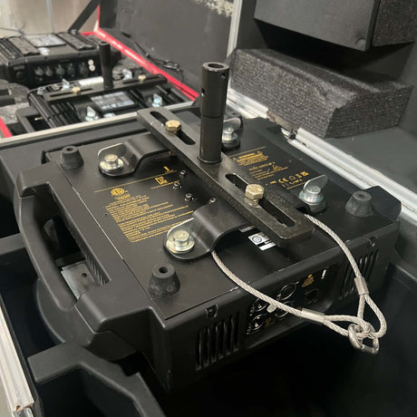 Moving Light Stand Adapter "Cotone Mount" securely attached to a professional lighting fixture in a travel case.