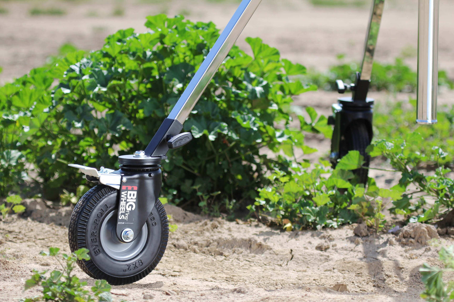 Big F’ing™ Wheel mounted on a stand, showcasing its durable foam tire and smooth movement in a field setting.