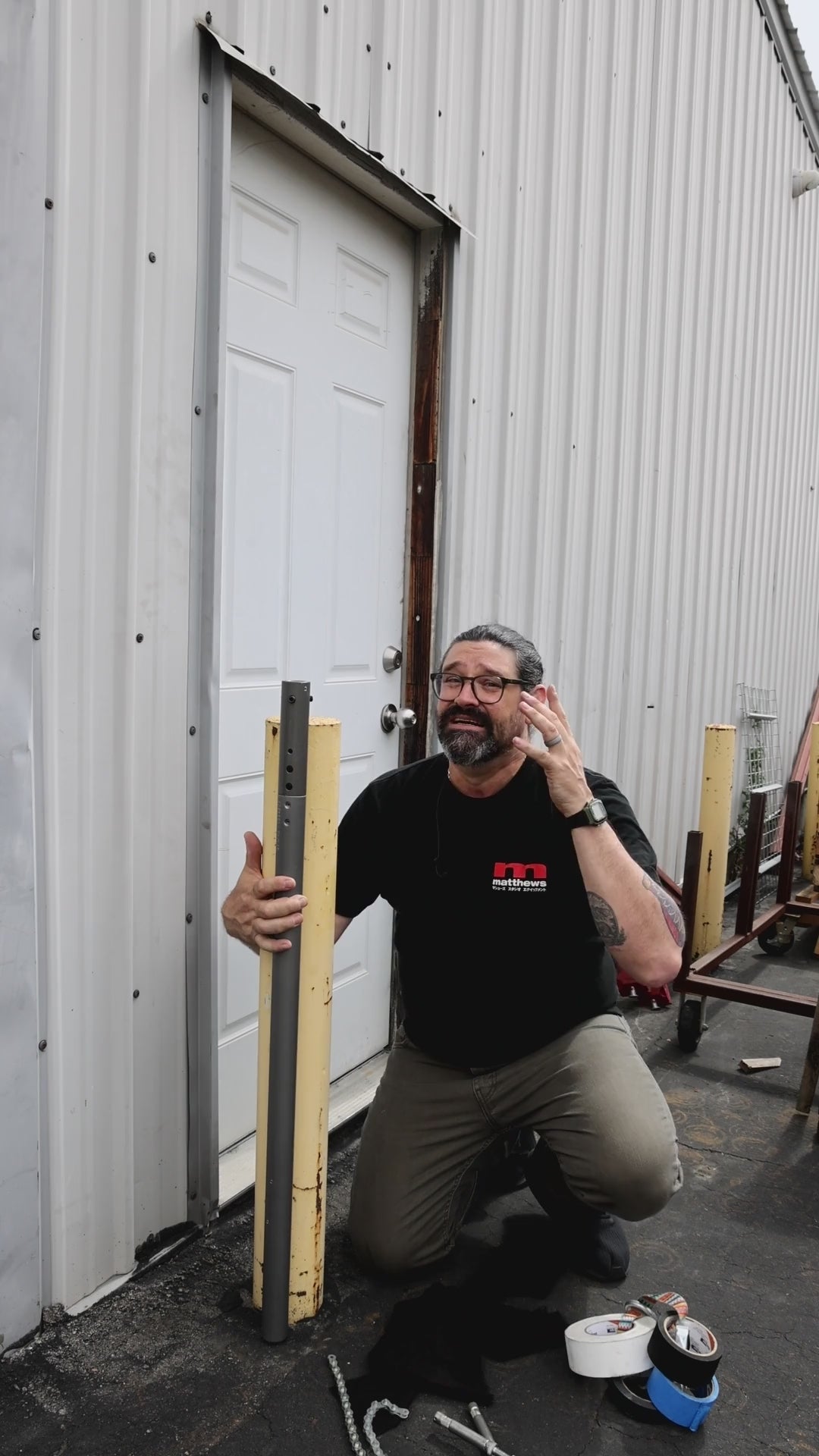 Grip Rail candlestick rig: rail strapped vertically to an existing post, then a lighting fixture mounted on the rail and adjusted