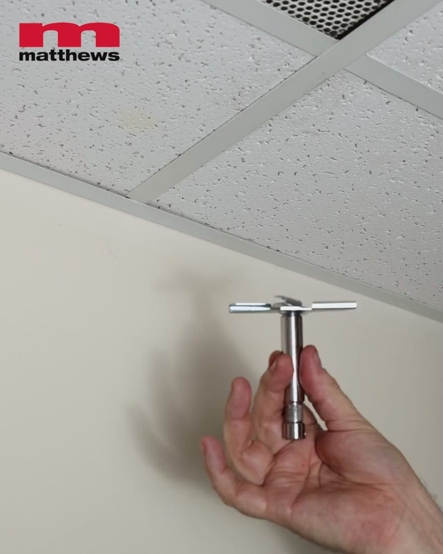 Drop ceiling scissor clamp, PN 429678, shown clamping into ceiling grid and holding a light